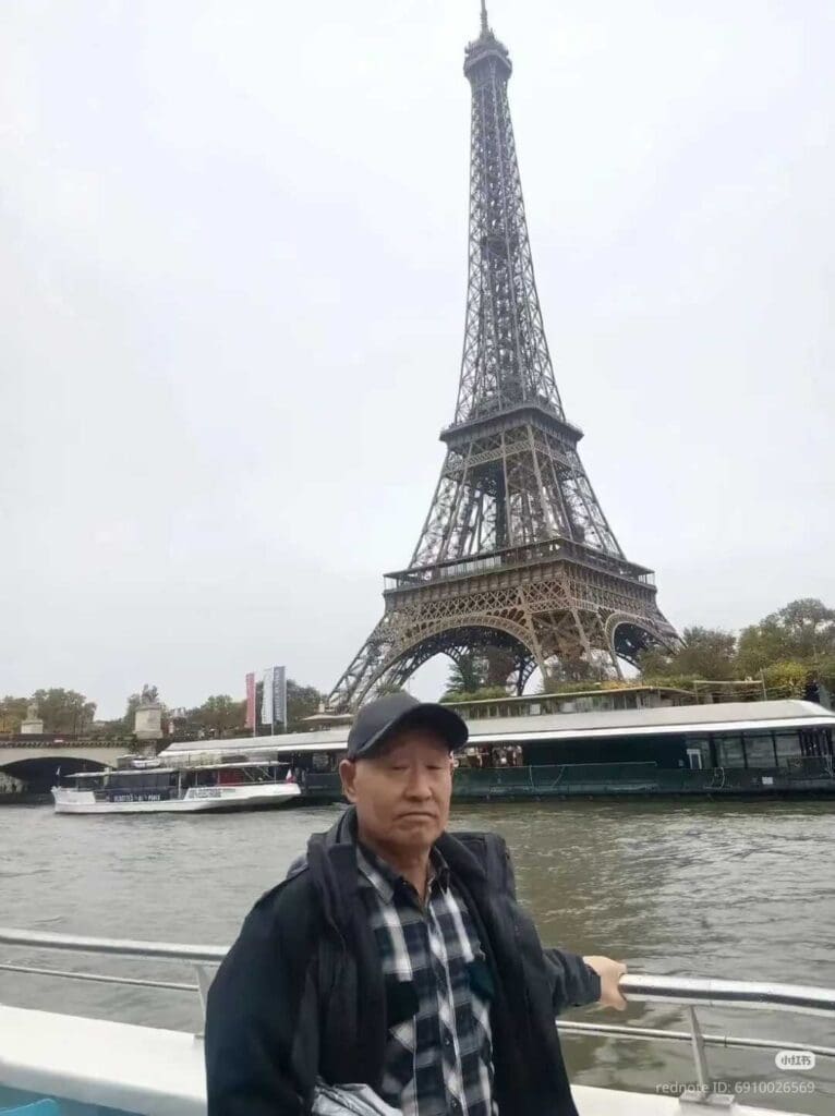 chinese tourist uncle zhang in front of eiffel tower